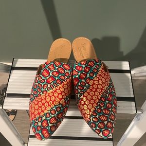 Designed in Africa, made in Mexico. Artisan flat mules.